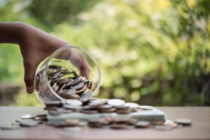 The picture shows the result of compounding Interest Strategies with a jar full of coins.